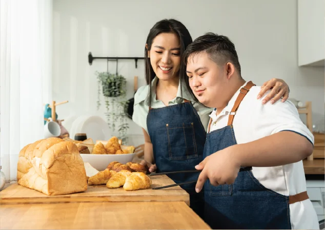 mother and son with special needs baking together in kitchen