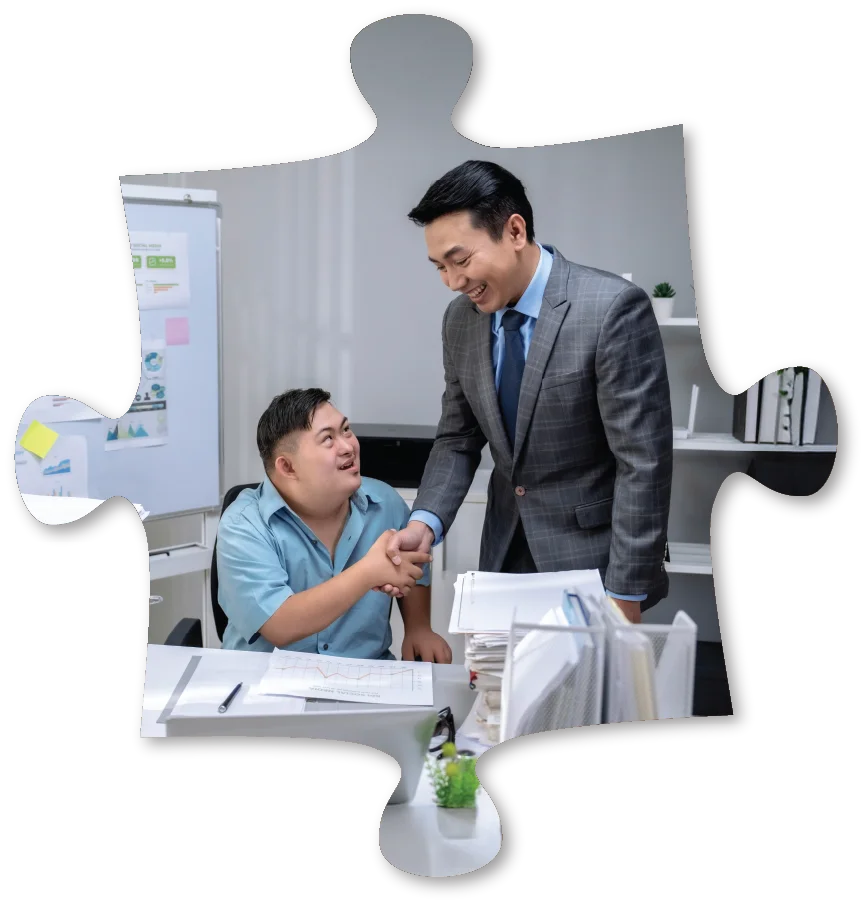puzzle shape featuring a smiling boss shaking employee's hand at his desk